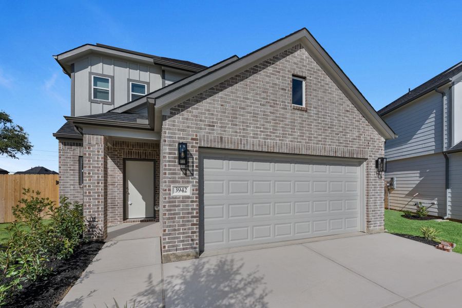 Front exterior of a new home in Grand Oaks Village, Houston, TX, highlighting curb appeal (Image 2). Front exterior of a new home in Grand Oaks Village, Houston, TX, highlighting curb appeal (Image 2).