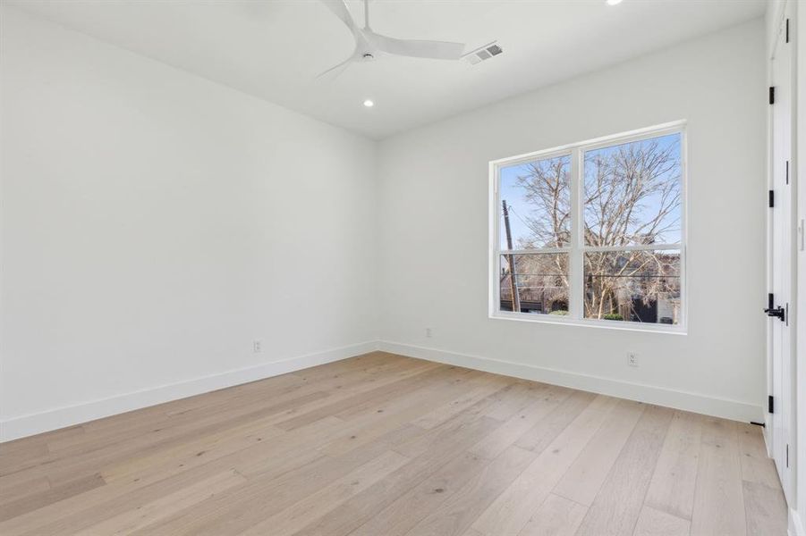 Spare room with ceiling fan and light wood-type flooring