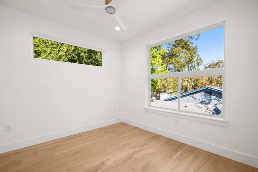 Second floor bedroom featuring wood finished floors, a ceiling fan, and recessed lighting Second floor bedroom featuring wood finished floors, a ceiling fan, and recessed lighting