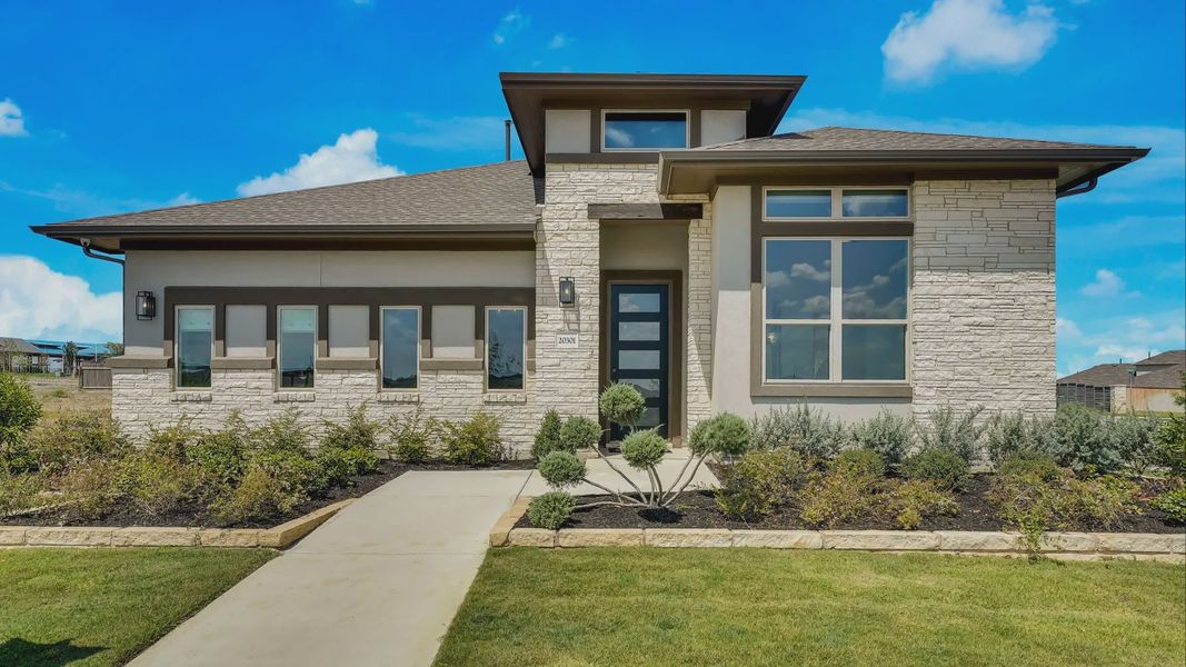 Representative exterior photo of a completed home built from the Willow by DRB Homes in Carillon, Manor, TX (Image 21).
