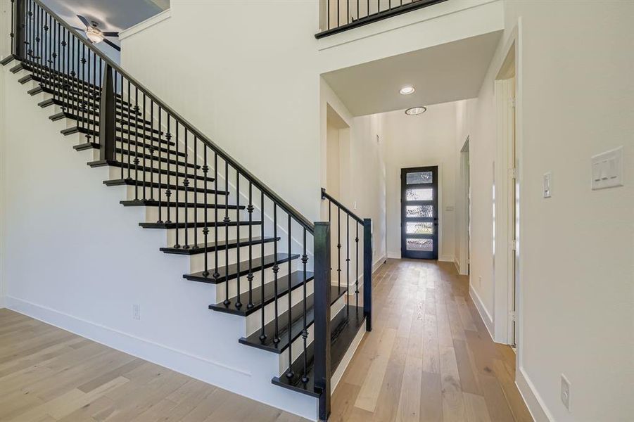 Foyer featuring light wood-style flooring, stairs, and recessed lighting Foyer featuring light wood-style flooring, stairs, and recessed lighting