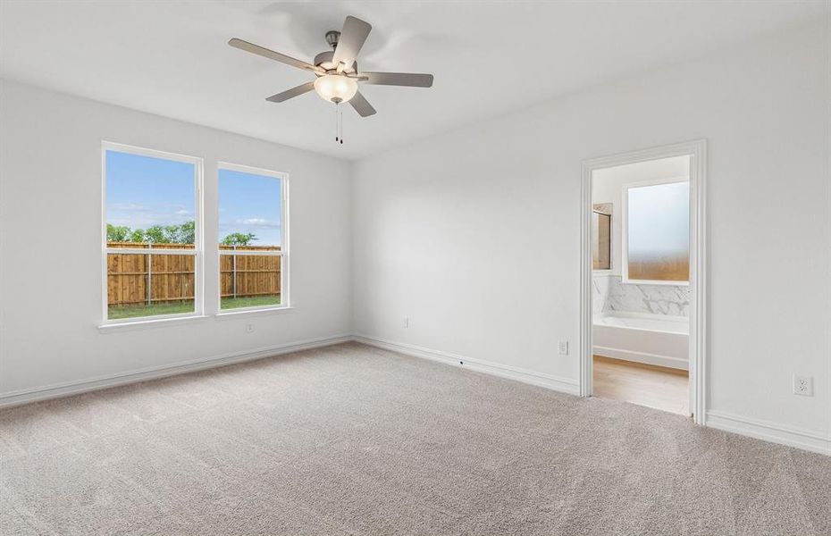 Primary bedroom with large windows