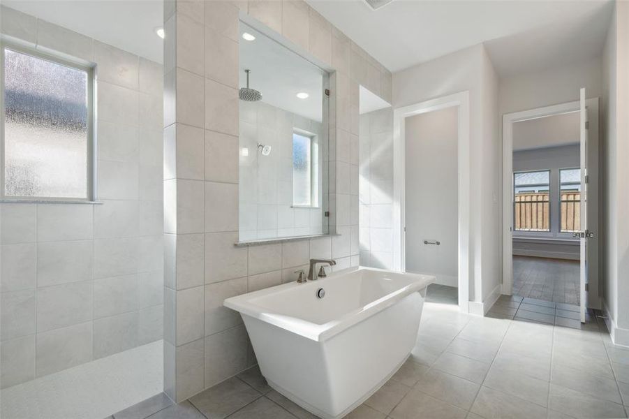 This fantastic owner's bath features our signature freestanding tub with walk through shower!