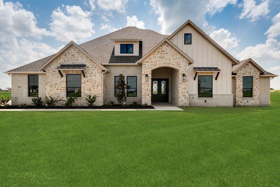 View of front facade featuring stone siding, board and batten siding, french doors, and a standing seam roof View of front facade featuring stone siding, board and batten siding, french doors, and a standing seam roof