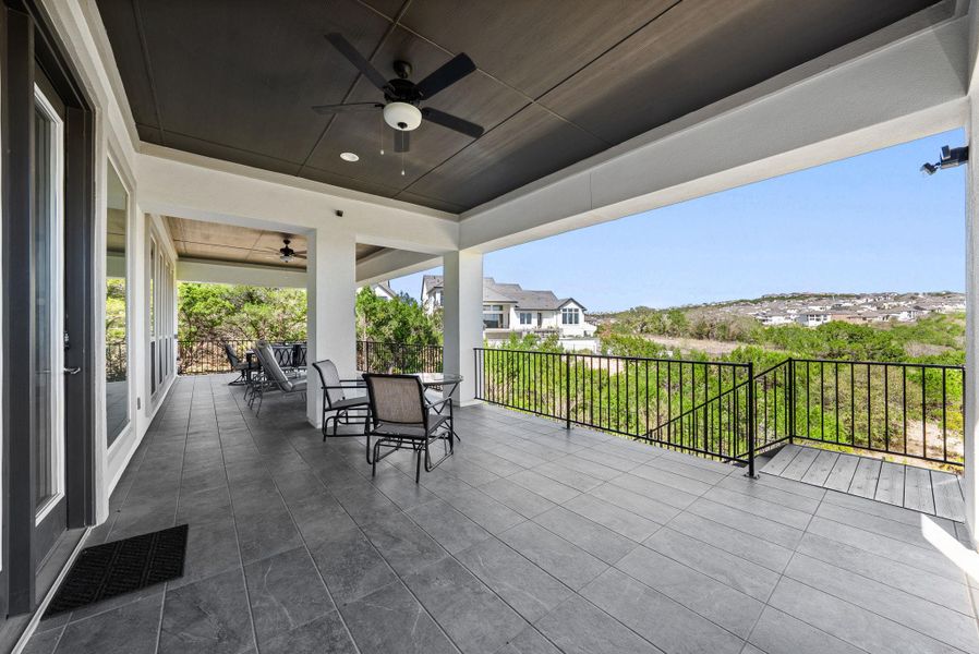 View of patio with ceiling fan, outdoor dining area, and a residential view