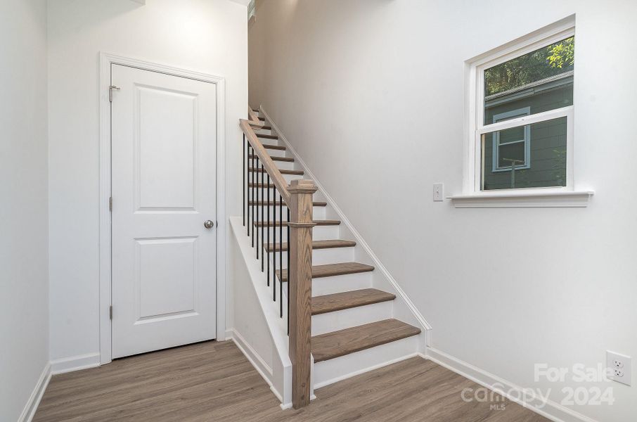 Representative Photo. Coat closet beside staircase leading upstairs