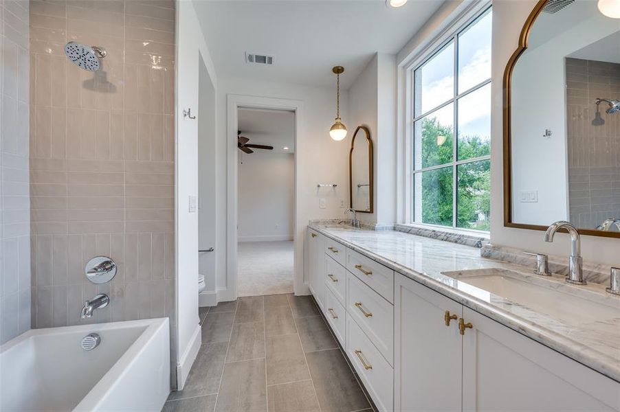 Full bath featuring double vanity, tile patterned floors, ceiling fan, recessed lighting, and  shower combination