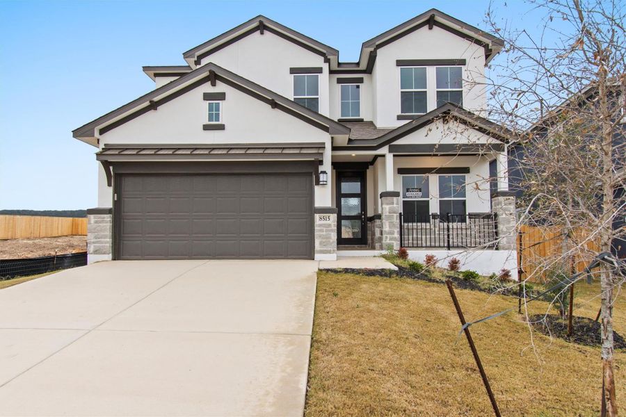 View of front of house featuring a garage and a front yard