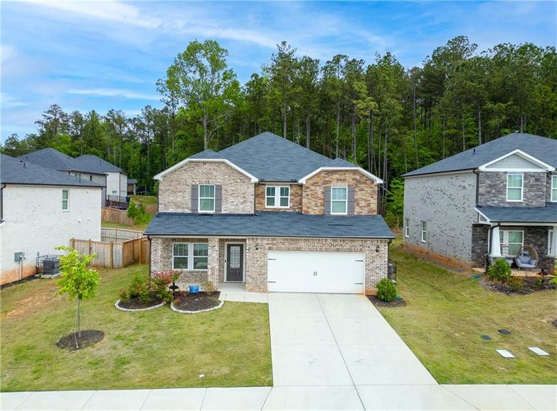Front exterior of a new home in Creekside at Oxford Park, Fairburn, GA, highlighting curb appeal (Image 22). Front exterior of a new home in Creekside at Oxford Park, Fairburn, GA, highlighting curb appeal (Image 22).