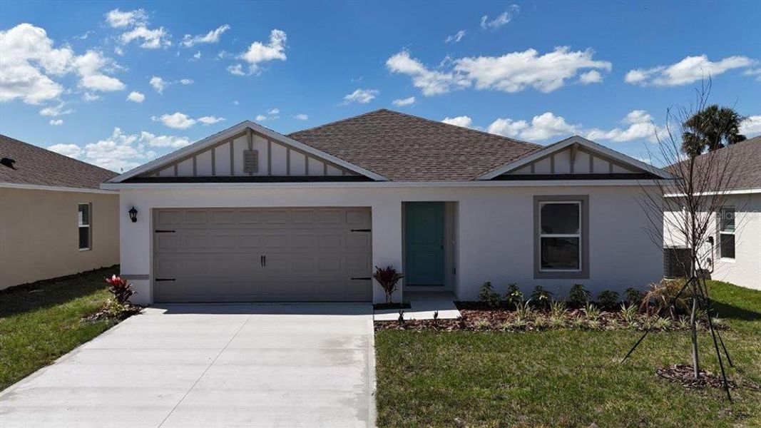 Front exterior of a new home in Leoma's Landing, Lake Wales, FL, highlighting curb appeal (Image 1). Front exterior of a new home in Leoma's Landing, Lake Wales, FL, highlighting curb appeal (Image 1).
