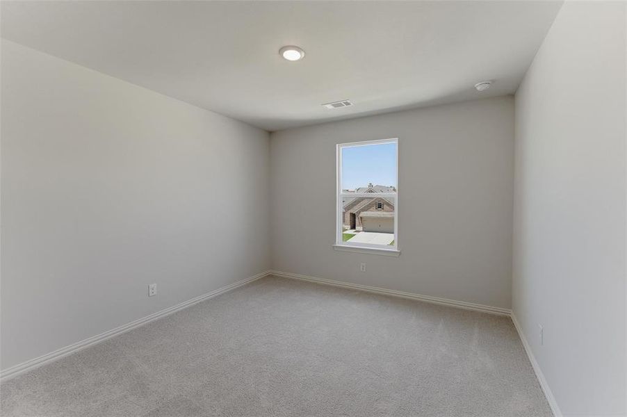 Room with light gray carpet flooring, white baseboards, and neutral wall paint