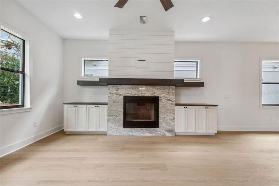 Family room with wood burning gas lit fireplace