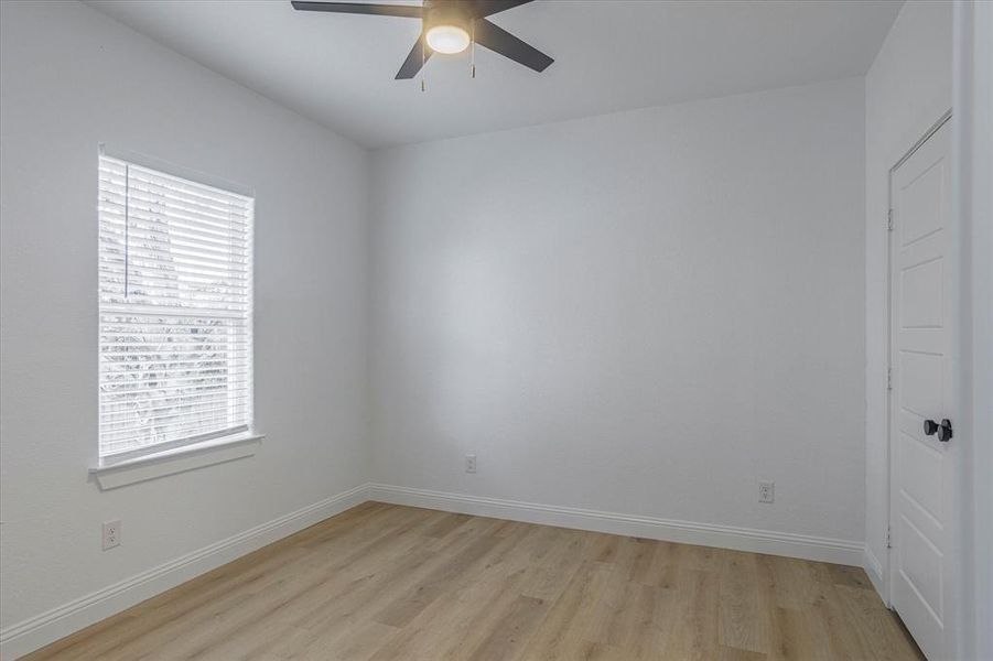 Unfurnished room featuring ceiling fan and light wood-type flooring