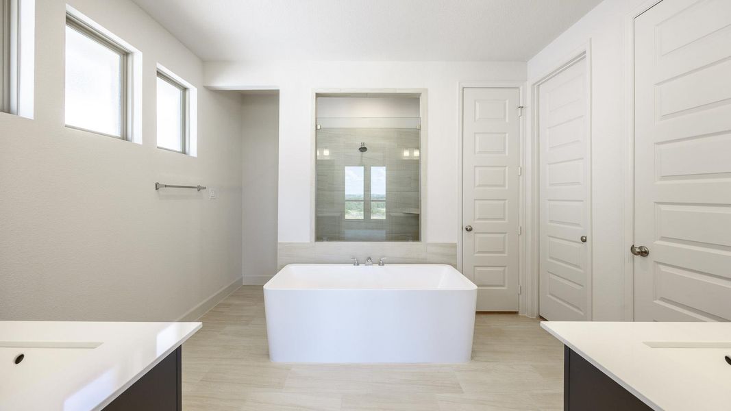 Full bathroom featuring vanity, walk in shower, and a freestanding bath Full bathroom featuring vanity, walk in shower, and a freestanding bath