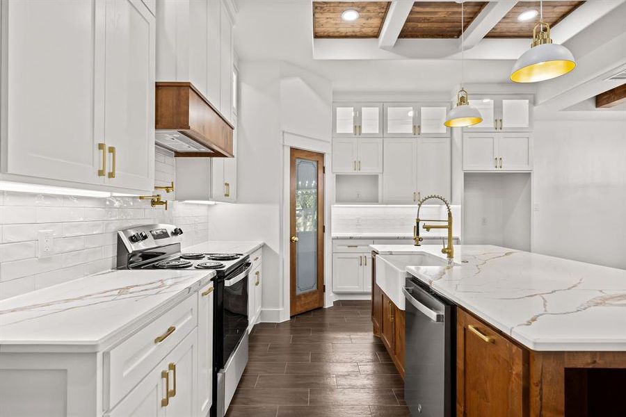 Kitchen with white cabinets, stainless steel appliances, glass insert cabinets, brown cabinets, and dark wood-style flooring Kitchen with white cabinets, stainless steel appliances, glass insert cabinets, brown cabinets, and dark wood-style flooring