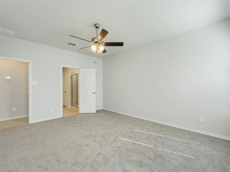 Unfurnished bedroom featuring visible vents, baseboards, a ceiling fan, and carpet floors Unfurnished bedroom featuring visible vents, baseboards, a ceiling fan, and carpet floors