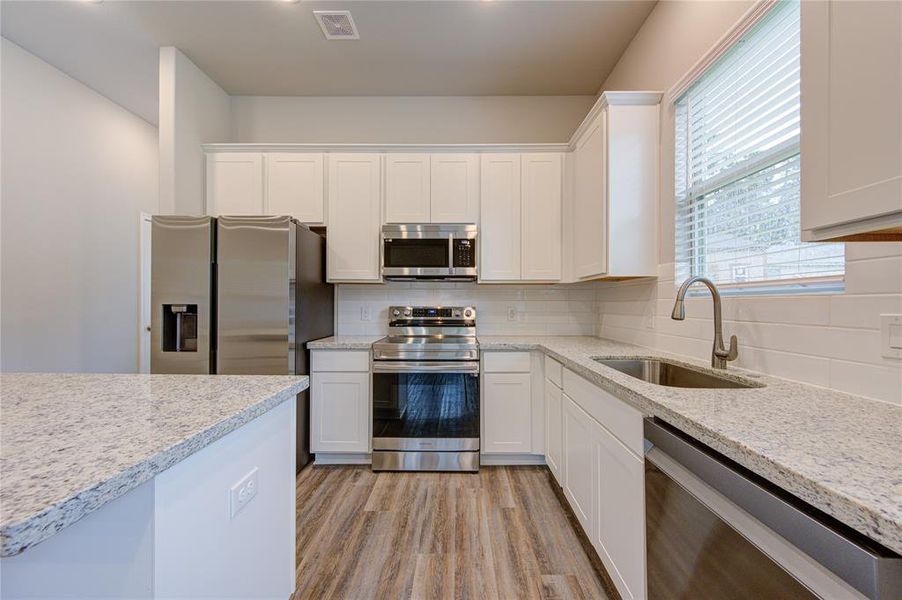 All stainless steel appliances in this incredible open concept