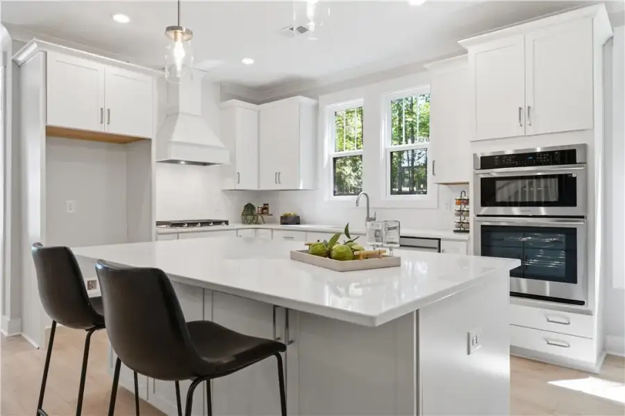 Gleaming stone countertops and shaker cabinetry fr