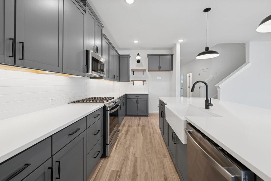 Stylish kitchen with grey cabinets and floating shelves Stylish kitchen with grey cabinets and floating shelves
