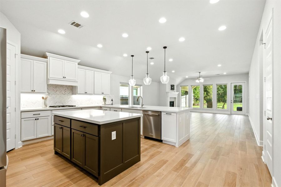 The spacious island kitchen opens to dining and living. The spacious island kitchen opens to dining and living.