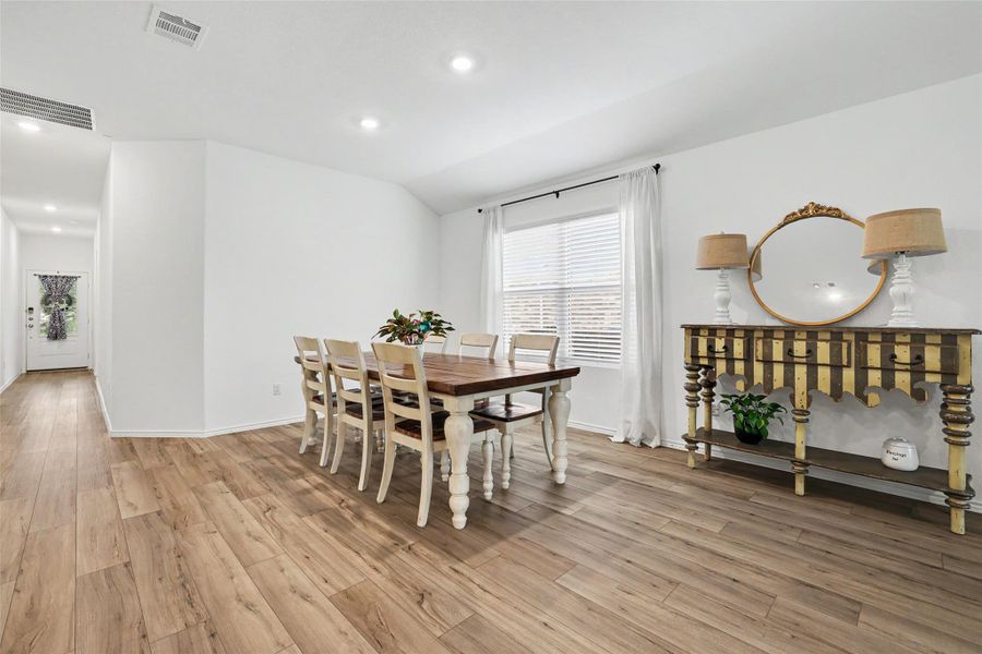 Spacious interior featuring wood-finish flooring, recessed lighting, and white walls