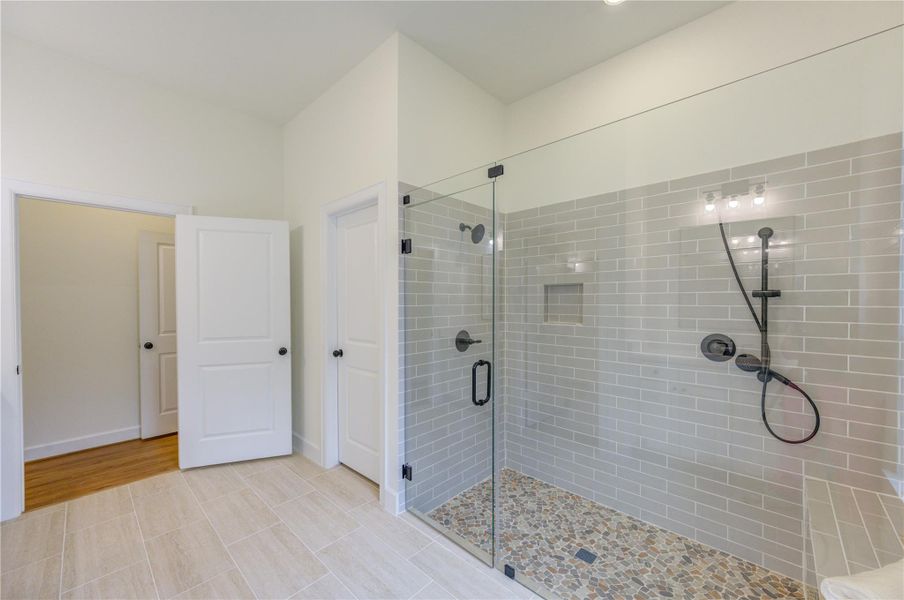 Discover luxury in this master ensuite featuring a sleek glass-enclosed shower with modern fixtures, elegant tile work, and a soothing neutral palette, offering a serene retreat in your new home. Discover luxury in this master ensuite featuring a sleek glass-enclosed shower with modern fixtures, elegant tile work, and a soothing neutral palette, offering a serene retreat in your new home.