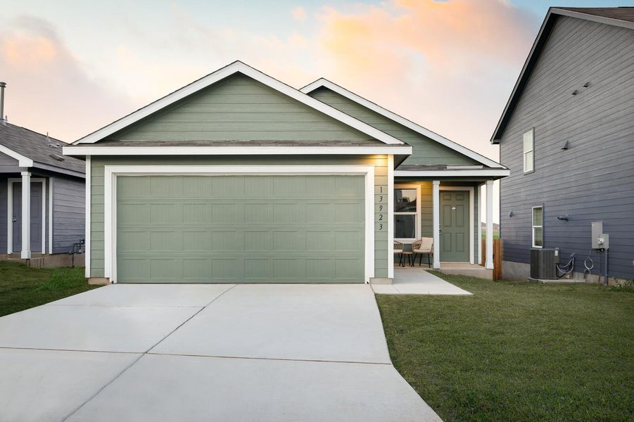 View of front of house with concrete driveway, a garage, and a front lawn View of front of house with concrete driveway, a garage, and a front lawn