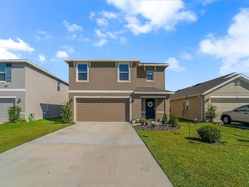 Front exterior of a new home in Evergreen, Bradenton, FL, highlighting curb appeal (Image 18).