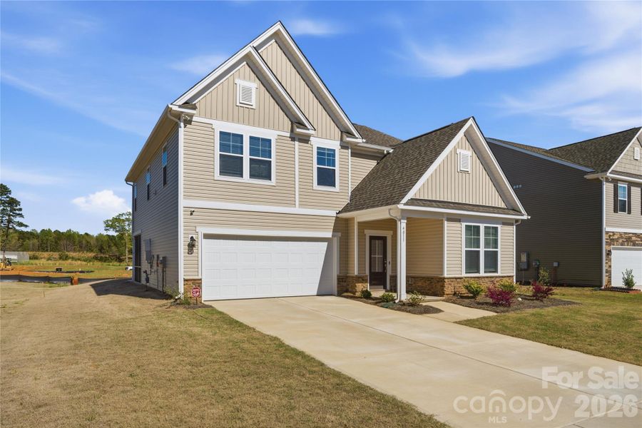 Front exterior of a new home in Clairmont, Charlotte, NC, highlighting curb appeal (Image 23).