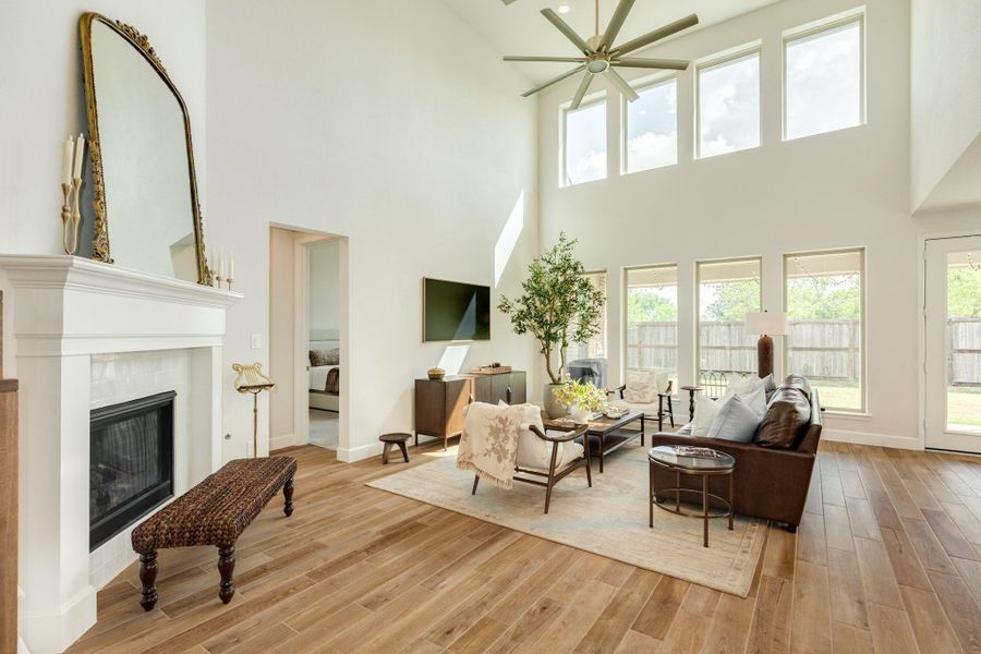 Elegant and spacious family room featuring abundant natural light, soaring high ceilings, and a modern ceiling fan—perfect for family gatherings or entertaining guests or jsut a relaxing night at home Elegant and spacious family room featuring abundant natural light, soaring high ceilings, and a modern ceiling fan—perfect for family gatherings or entertaining guests or jsut a relaxing night at home