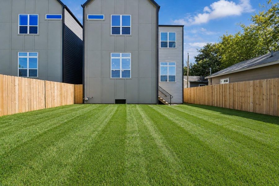 Expansive fenced backyard is ready for your vision. Freshly manicured lawn provides a clean, versatile outdoor setting with ample space for pets, play, gardening, or future outdoor entertaining.