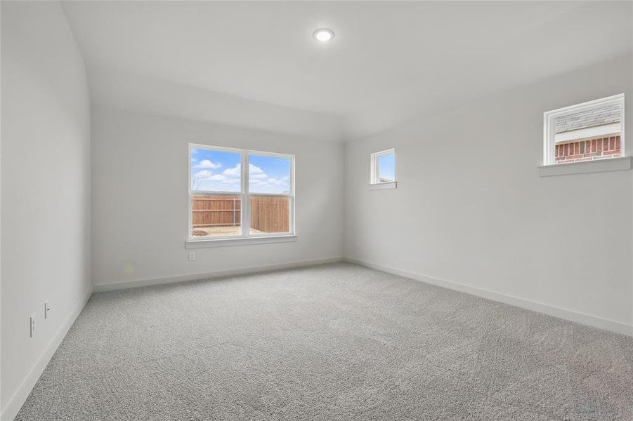 Unfurnished room with carpet flooring and baseboards Unfurnished room with carpet flooring and baseboards