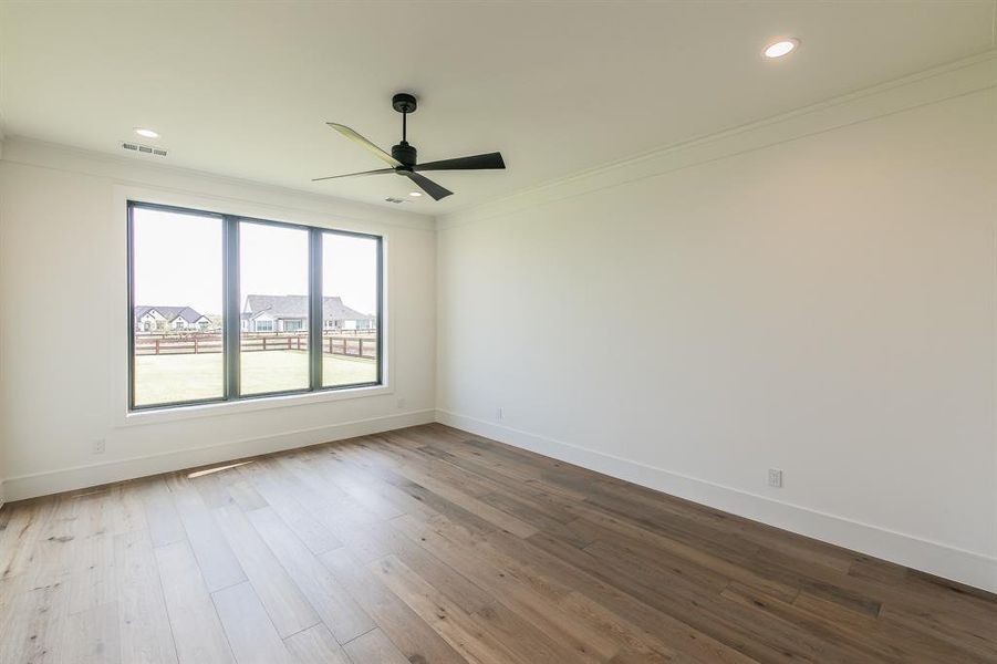 Spare room featuring wood-type flooring, ornamental molding, ceiling fan, and recessed lighting