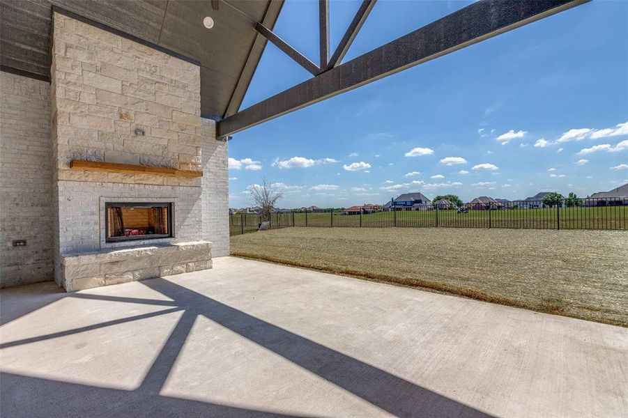 View of patio featuring an outdoor stone fireplace