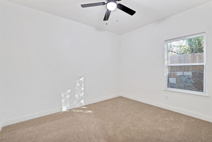 Unfurnished room with ceiling fan and carpet floors