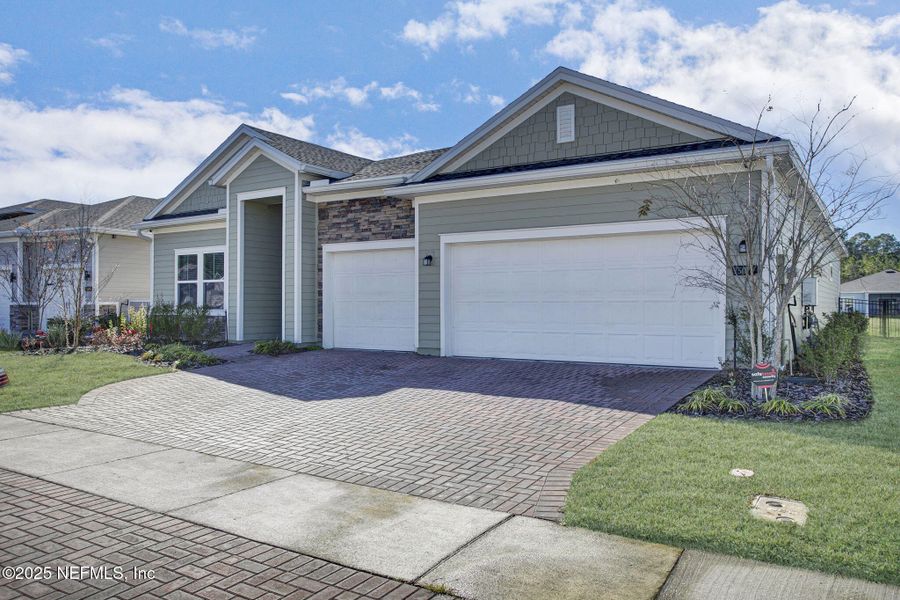 Front exterior of a new home in Tributary: Lakeview at Tributary 60's, Yulee, FL, highlighting curb appeal (Image 21).
