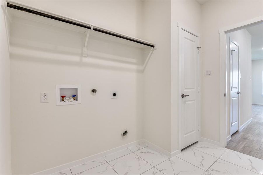 Laundry room featuring washer hookup, electric dryer hookup, light marble finish floors, and gas dryer hookup