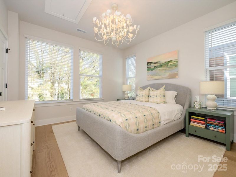 On the upper level is this stately primary bedroom.  I know, that light is gorgeous but it also sentimental to the seller and will be replaced with somethig similar prior to closing.