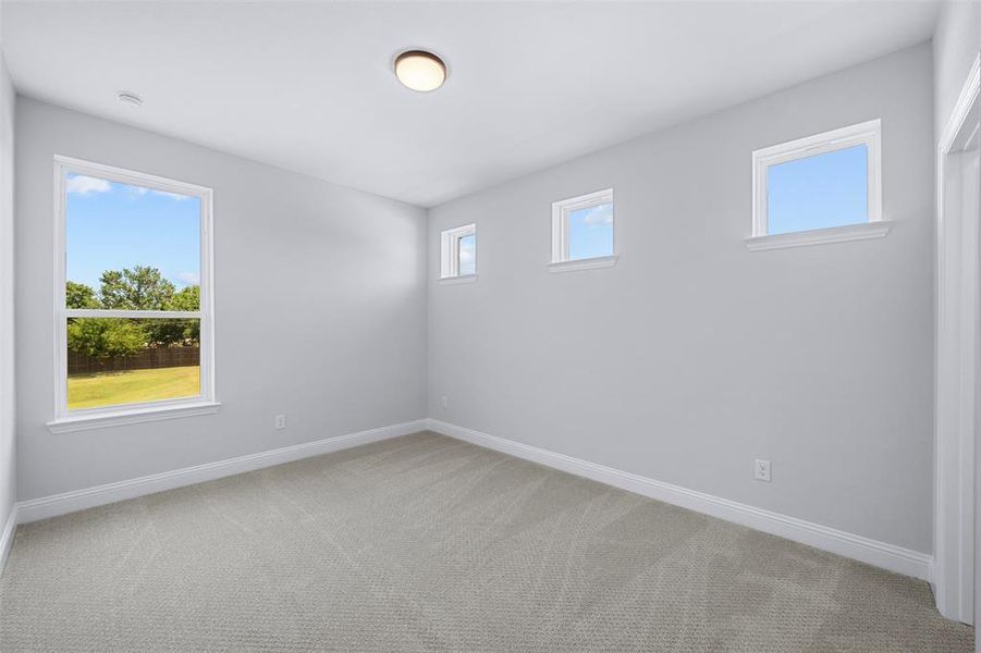 Empty room with carpet floors and baseboards