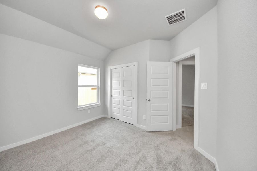 Generously sized secondary bedrooms, complete with spacious closets and soft, inviting carpeting. Enjoy abundant natural light streaming in through the large windows, complemented by privacy blinds for your personal sanctuary. Sample photo of completed home with similar floor plan. Actual colors and selections may vary.