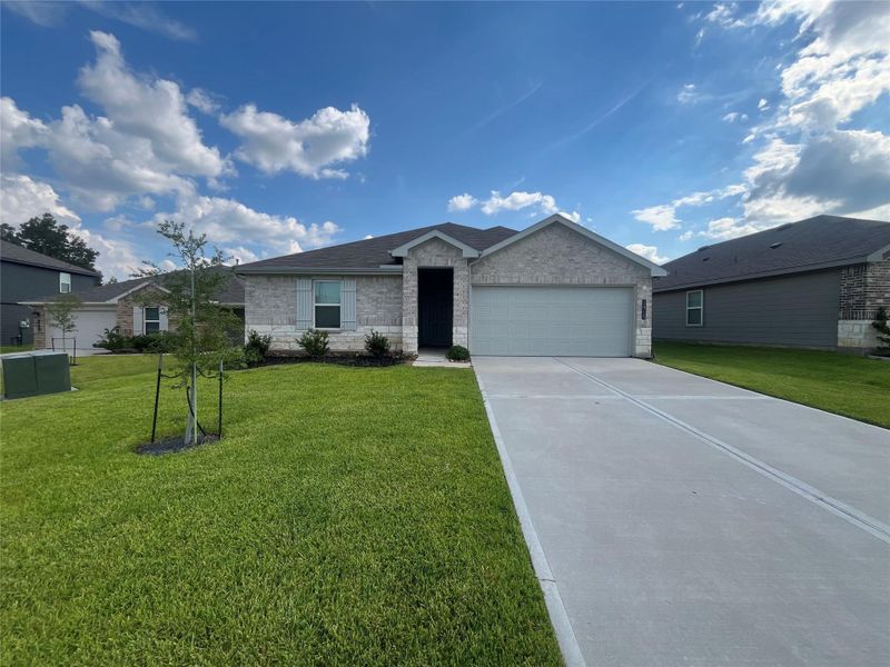 Front exterior of a new home in Grand Pines, Magnolia, TX, highlighting curb appeal (Image 2).