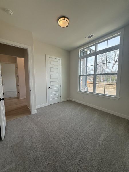 Unfurnished bedroom featuring carpet floors and baseboards