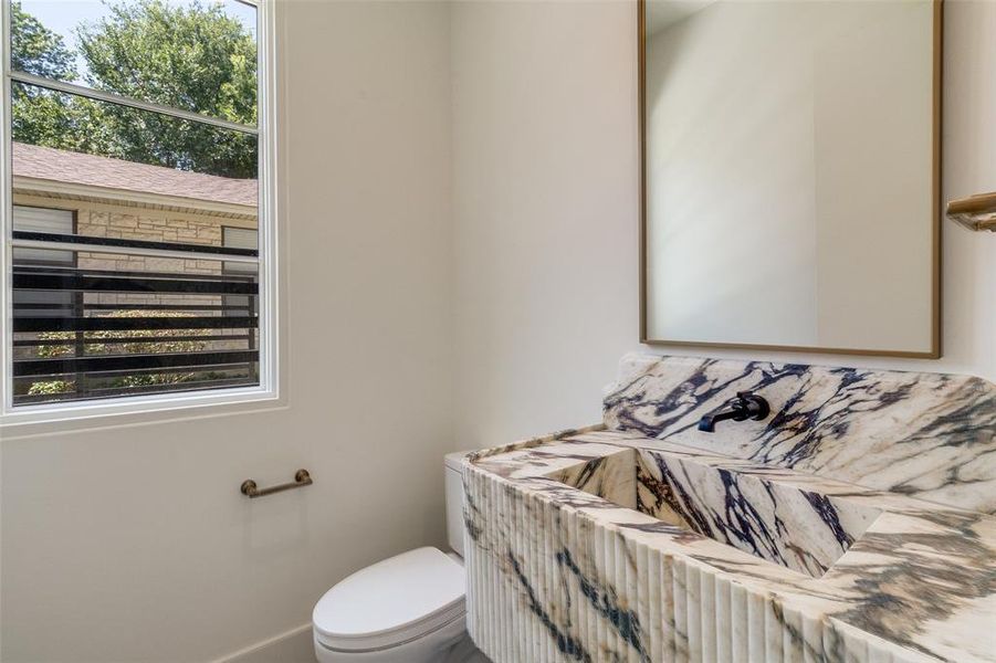 Bathroom featuring toilet and baseboards Bathroom featuring toilet and baseboards