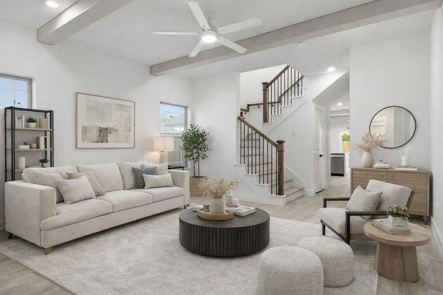 The living room features two large windows, a ceiling fan, stylish beams, and luxury vinyl flooring. (staged)
