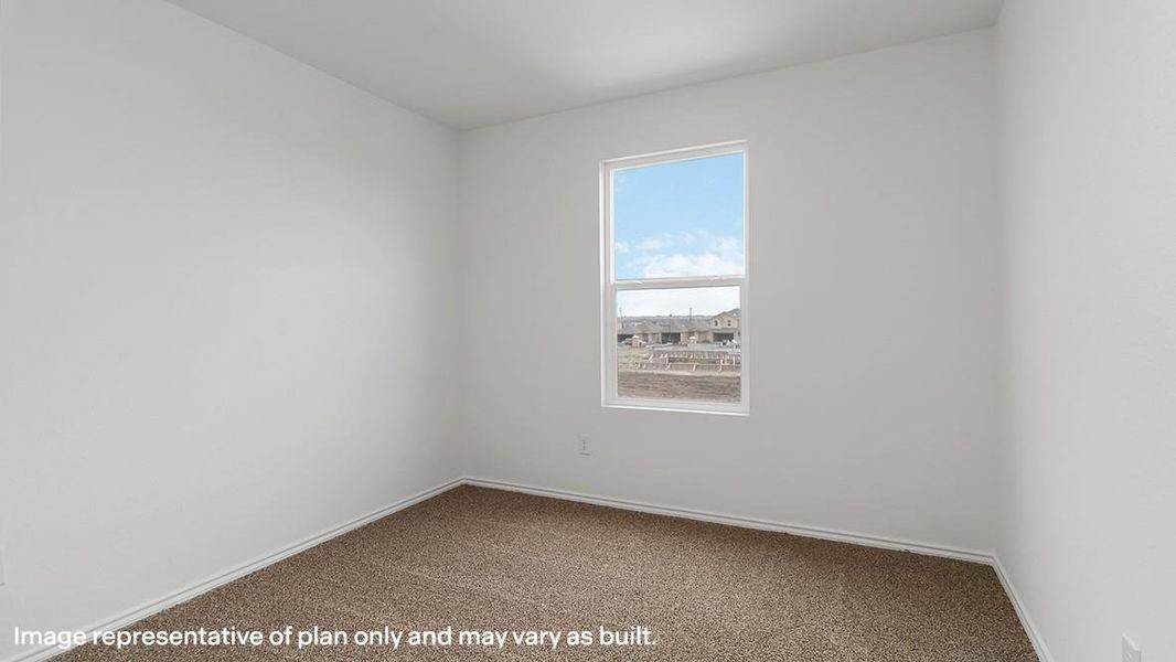 Carpeted spare room with baseboards