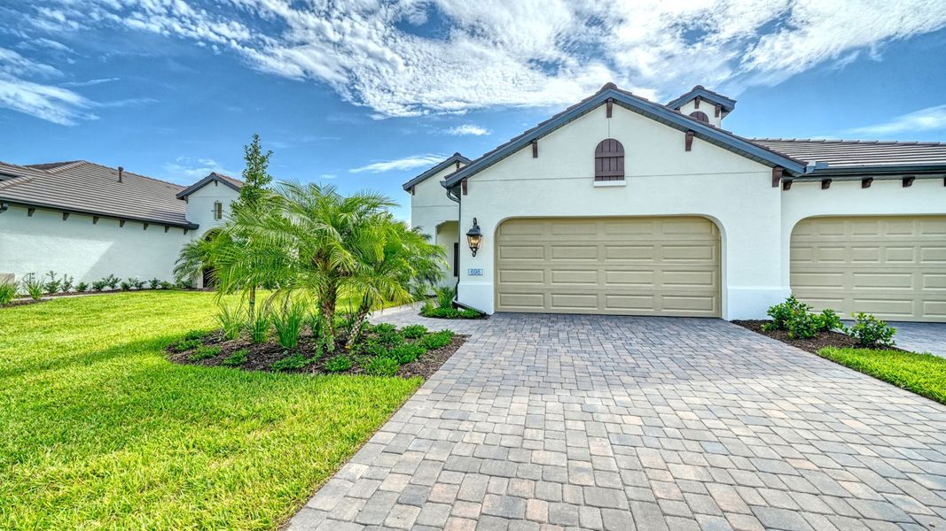 Front exterior of a new home in Vistera of Venice Real Estate and Homes for Sale in Venice, FL - Neal Communities, Venice, FL, highlighting curb appeal (Image 1). Front exterior of a new home in Vistera of Venice Real Estate and Homes for Sale in Venice, FL - Neal Communities, Venice, FL, highlighting curb appeal (Image 1).