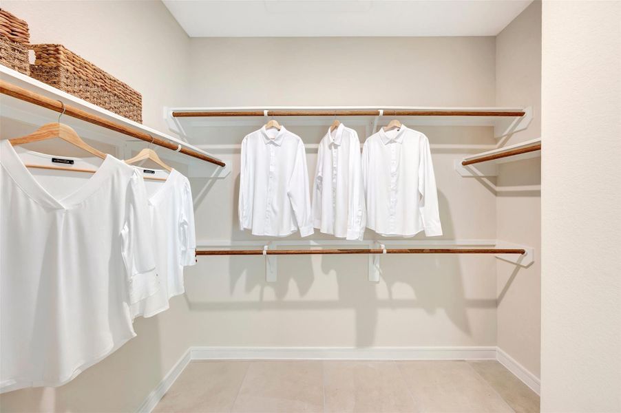 Walk-in closet in the primary suite (*Photo not of actual home and used for illustration purposes only.) Walk-in closet in the primary suite (*Photo not of actual home and used for illustration purposes only.)