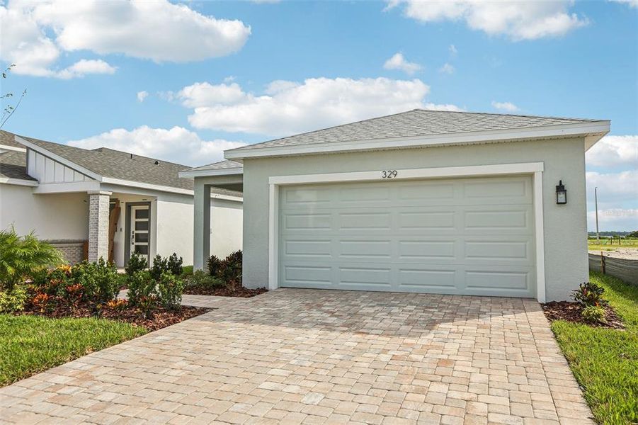 Front exterior of a new home in Willowbrook North, Winter Haven, FL, highlighting curb appeal (Image 18). Front exterior of a new home in Willowbrook North, Winter Haven, FL, highlighting curb appeal (Image 18).