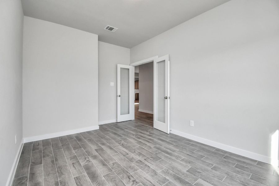 Step into the inviting home office, where elegant tile flooring adds a touch of freshness and comfort to the workspace. Natural light pours through the window, creating an inspiring environment for productivity and focus. Sample photo of completed home with similar floor plan. Actual colors and selections may vary. Step into the inviting home office, where elegant tile flooring adds a touch of freshness and comfort to the workspace. Natural light pours through the window, creating an inspiring environment for productivity and focus. Sample photo of completed home with similar floor plan. Actual colors and selections may vary.