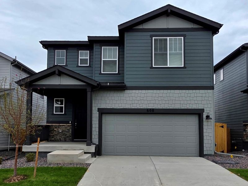 Front exterior of a new home in Lake Bluff, Greeley, CO, highlighting curb appeal (Image 1). Front exterior of a new home in Lake Bluff, Greeley, CO, highlighting curb appeal (Image 1).
